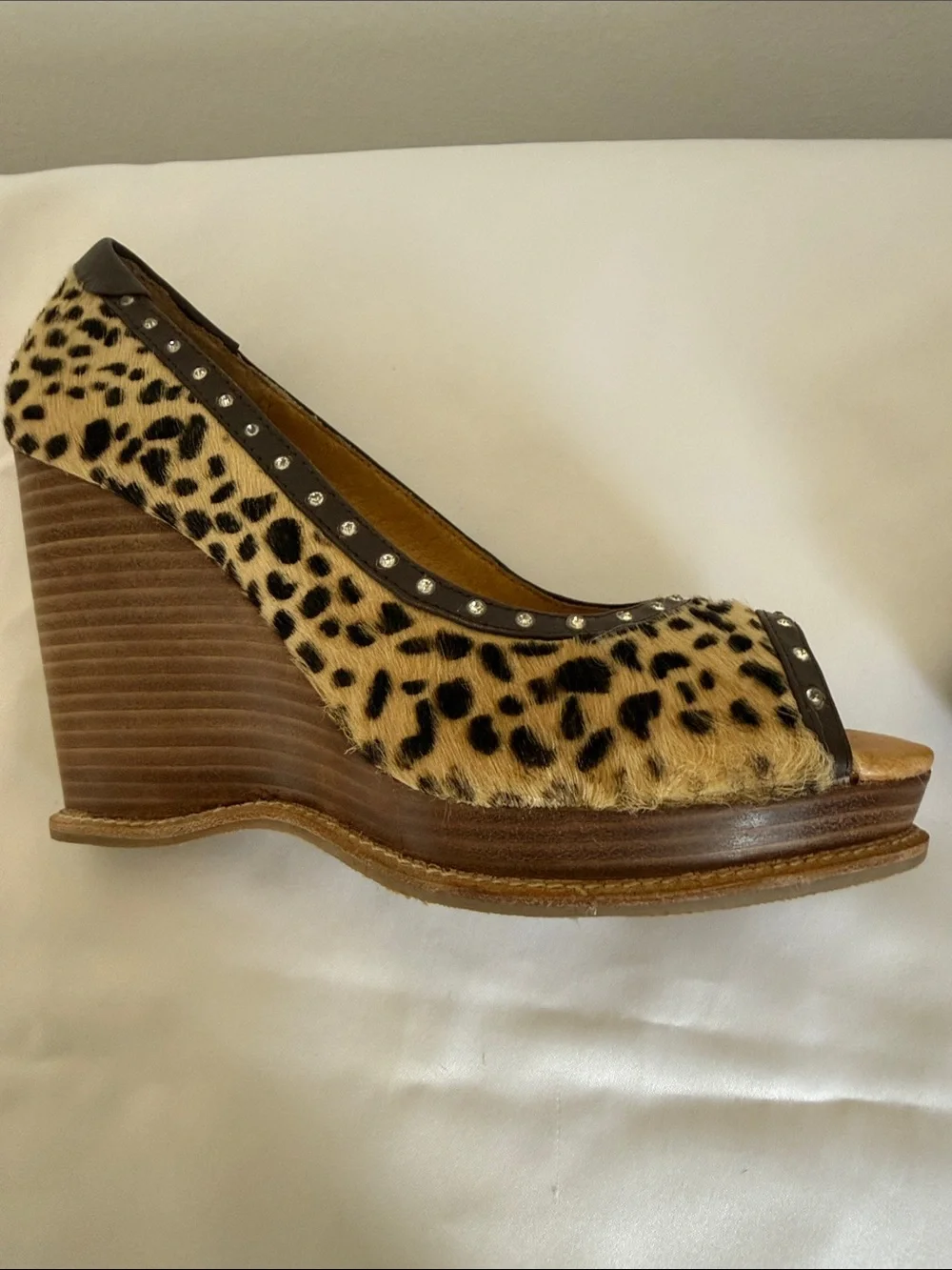 Animal print wedges with rhinestone trim. Leather upper size 8.